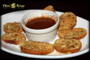 Tomato Infused Oil with Grilled Crostinis - Three Kings Pub
